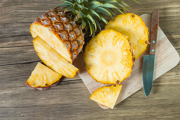 istock pineapple on the wood texture background 513252542