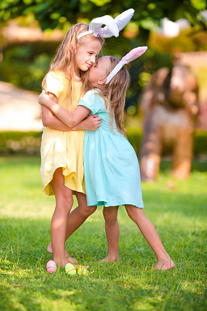 istock Two adorable little sisters wearing bunny ears on Easter 513252714