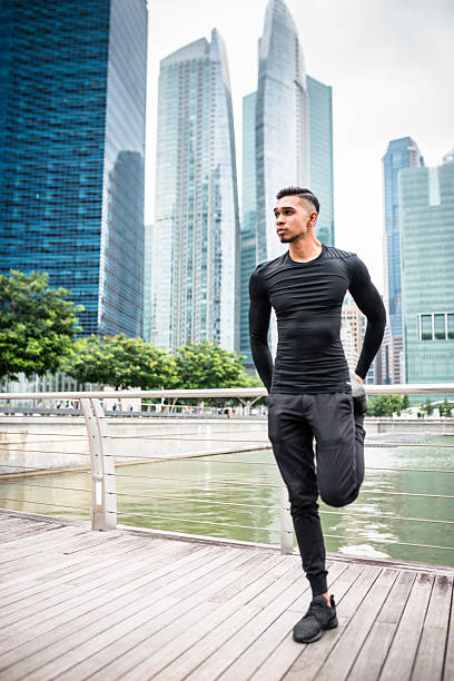 istock Asian man stretching his leg on singapore 513253282