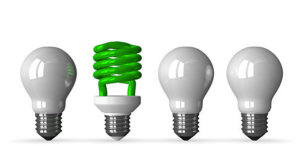 istock Green spiral light bulb and three white tungsten ones 513255873