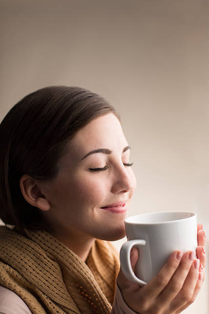 istock Hispanic woman enjoying scent of tea 513257481