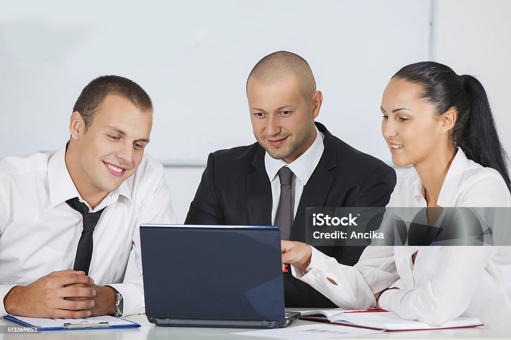 business people Image of business partners discussing documents and ideas at meeting in office Adult Stock Photo