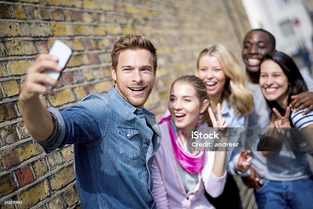 Friends talking a selfie Group of friends talking a selfie with a phone 20-29 Years Stock Photo