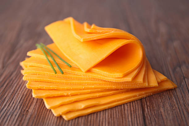 sliced cheese sliced cheese cheddar cheese photos stock pictures, royalty-free photos & images
