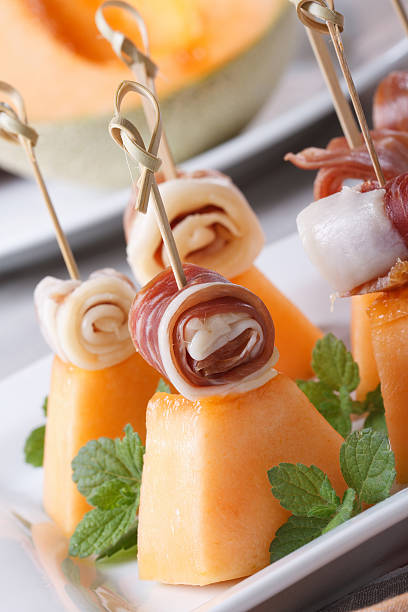 istock Finger food: ham and melon on skewers vertical 513274071