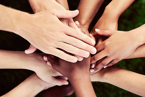 istock All for one! Many hands stacked in mutual support. 513274575