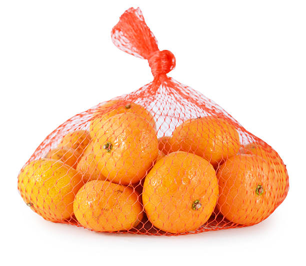 istock Fresh orange in plastic netting sack on white background 513274979