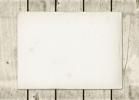 Blank vintage paper sheet on a white wood board panel