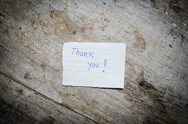 istock Thank you - Hand writing text on wood background 513292459
