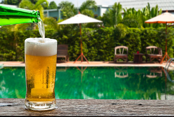 istock Enjoy beer beside swimming pool. 513293793