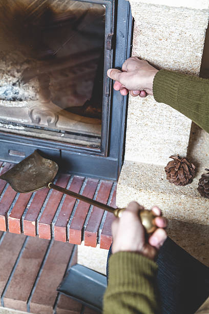istock Hand man opens door of fireplace 513294634