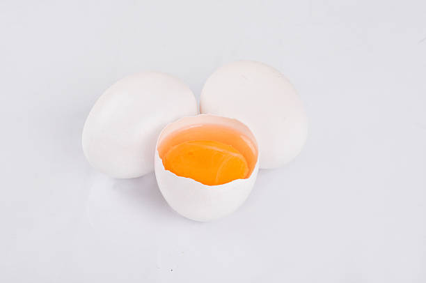 istock Whole and broken raw white eggs on white background 513294944