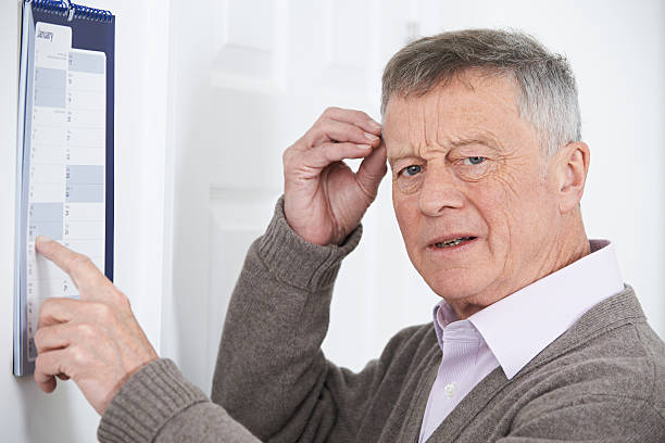 istock Confused Senior Man With Dementia Looking At Wall Calendar 513295604