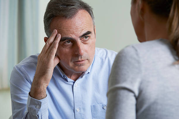 istock Depressed Mature Man Talking To Counsellor 513296022