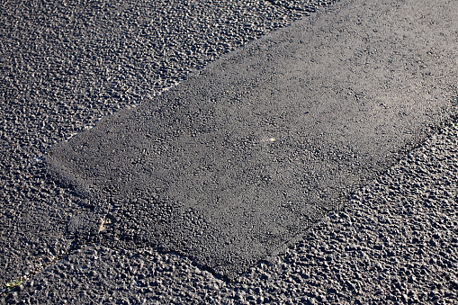 Asphalt Tarmac Patch on Concrete Ground Repair Pavement Road in Parking Lot