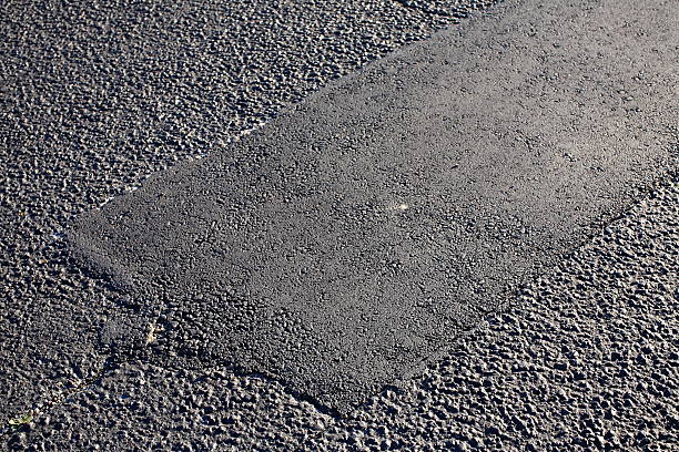 Asphalt Tarmac Patch Concrete Ground Repair Pavement Road Parking Lot Asphalt Tarmac Patch on Concrete Ground Repair Pavement Road in Parking Lot asphalt stock pictures, royalty-free photos & images