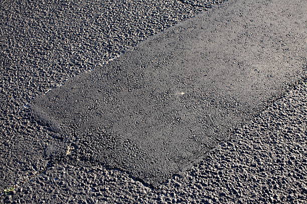 Asphalt Tarmac Patch Concrete Ground Repair Pavement Road Parking Lot Asphalt Tarmac Patch on Concrete Ground Repair Pavement Road in Parking Lot textile patch stock pictures, royalty-free photos & images