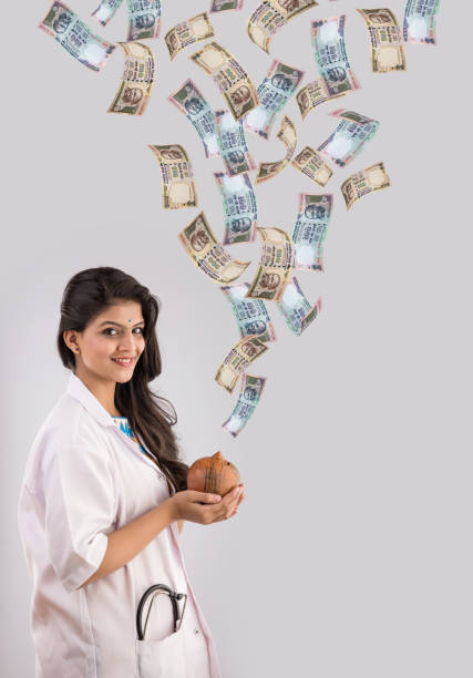istock indian lady doctor and indian currency notes flying, saving concept 513296440