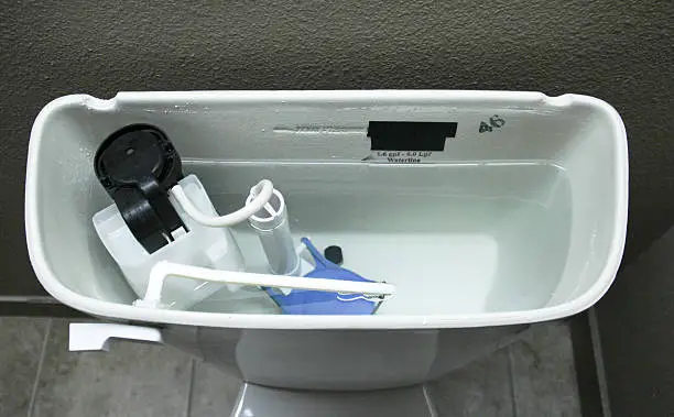 Internal plumbing of the inside of a tank of a modern toilet