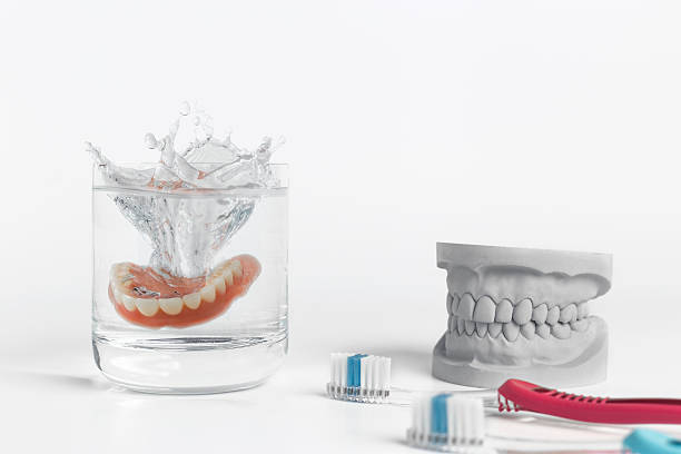 istock Denture hygiene concept with glass and toothbrush 513298298