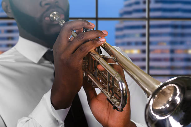 istock Trumpet player on city background. 513299194