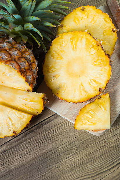 istock pineapple on the wood texture background 513300594