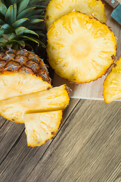istock pineapple on the wood texture background 513301056