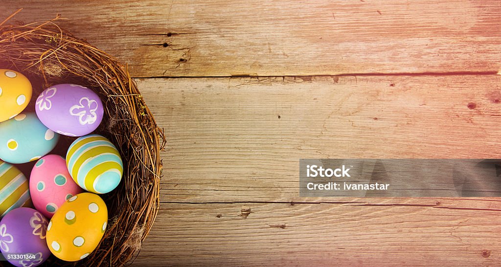 Easter Basket with Colored Eggs Colorful Easter Eggs in a Bird’s Nest Easter Stock Photo