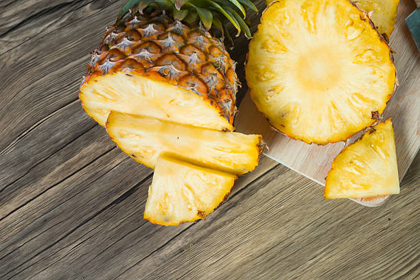 istock pineapple on the wood texture background 513301718