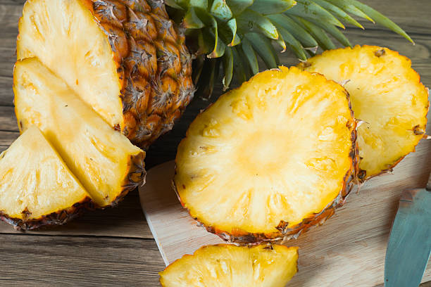 istock pineapple on the wood texture background 513302384