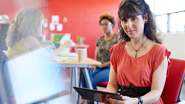 istock Confident female designer working on a digital tablet in red 513302390