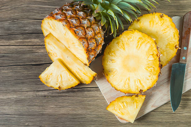 istock pineapple on the wood texture background 513302772