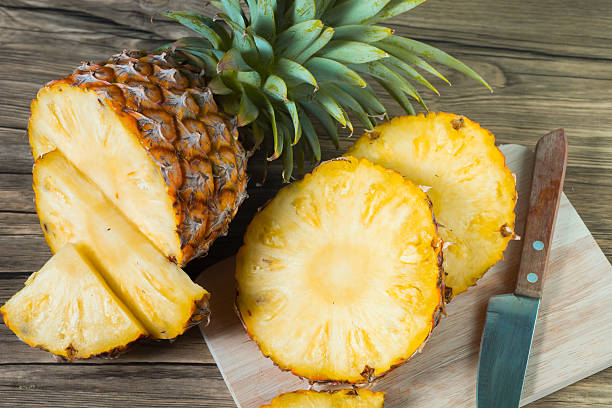 istock pineapple on the wood texture background 513302898