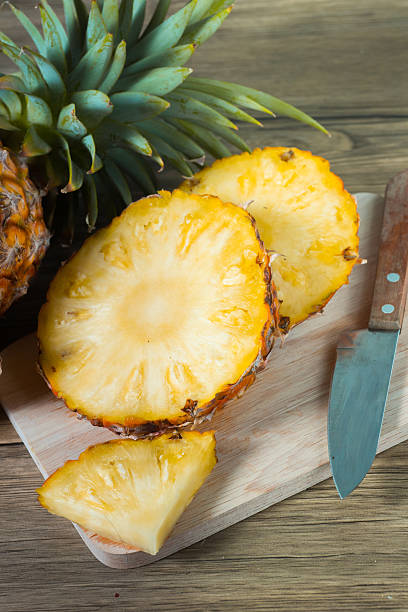 istock pineapple on the wood texture background 513303016