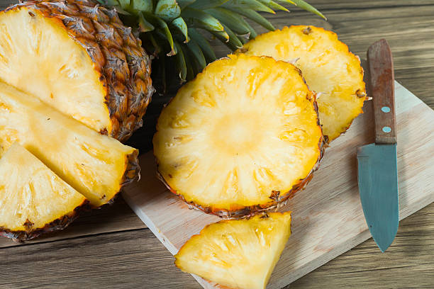 istock pineapple on the wood texture background 513303140