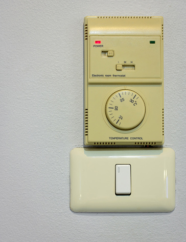 light switch and air conditioning control on wall