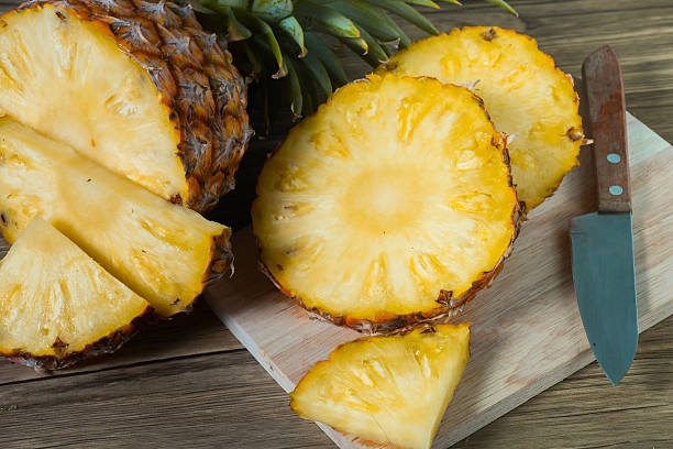 istock pineapple on the wood texture background 513303292