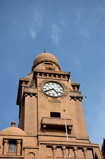 Karachi, Pakistan - February 22, 2015: A view of the King George V Silver Jubilee clock tower atop the restored historic Karachi Municipal Corporation (KMC) building located in Karachi's M.A. Jinnah Road. The building was completed in 1930 and is one of the city's many colonial landmarks.