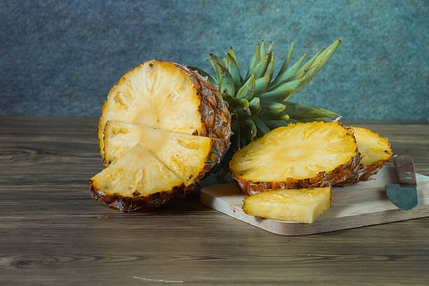 istock pineapple on the wood texture background 513303558