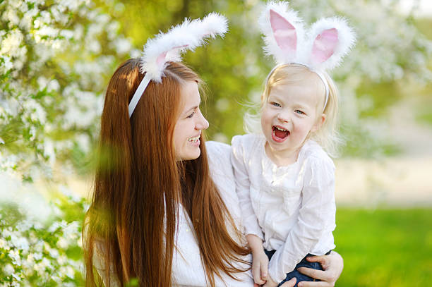 istock Mother and daughter wearing bunny ears on Easter 513303640