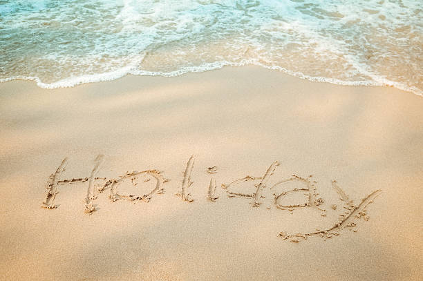 istock Holiday message hand writing on the sand beach 513304968