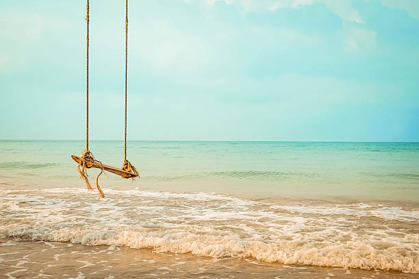 istock Wooden swing on  tropical beach 513305274