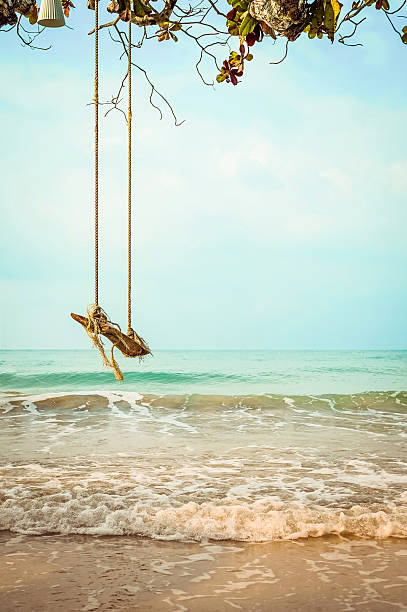 istock Wooden swing on  tropical beach 513305300