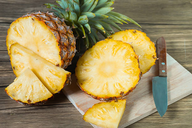istock pineapple on the wood texture background 513305612