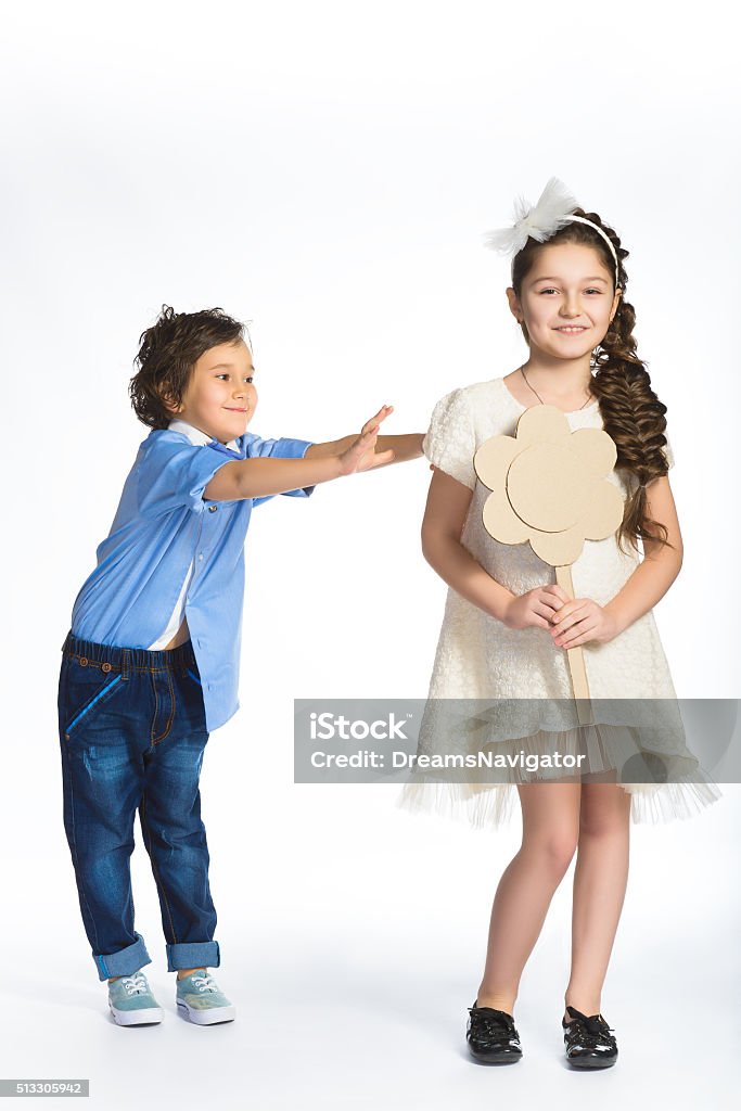 Boy and girl holding a cardboard heart. Love concept Boy and girl holding a cardboard heart. Love concept. Boys Stock Photo