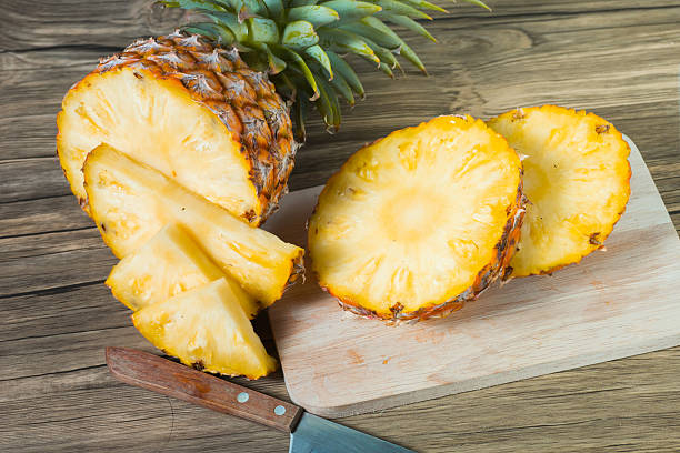 istock pineapple on the wood texture background 513306306