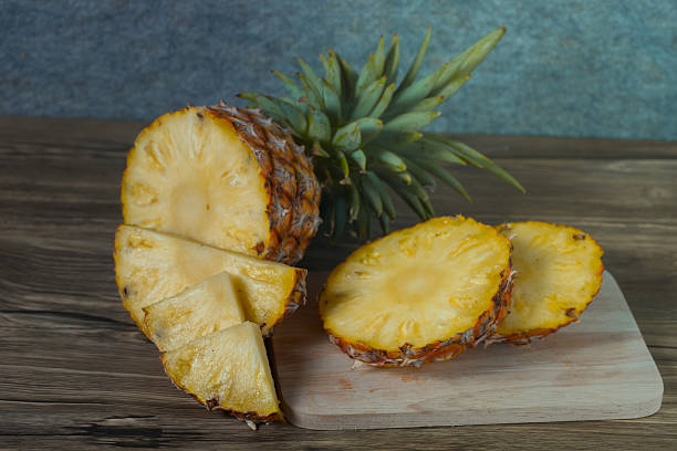 istock pineapple on the wood texture background 513308144