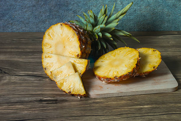 istock pineapple on the wood texture background 513308766