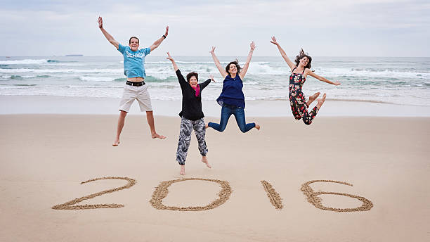 istock Family jumping on the beach together for 2016 513308910