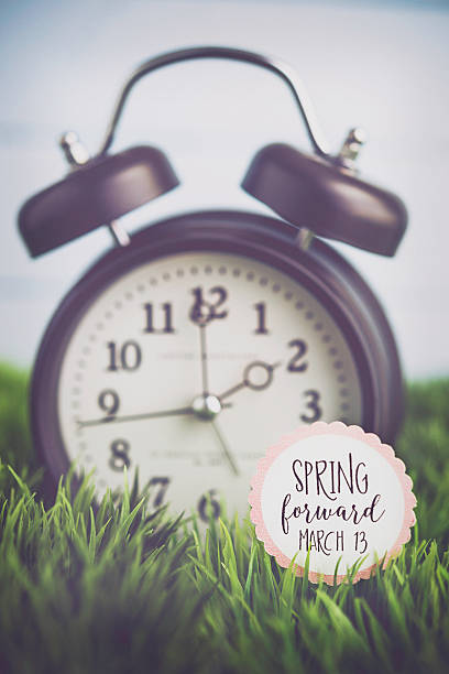 istock Clock in grass with reminder for Daylight Savings Time 513309072